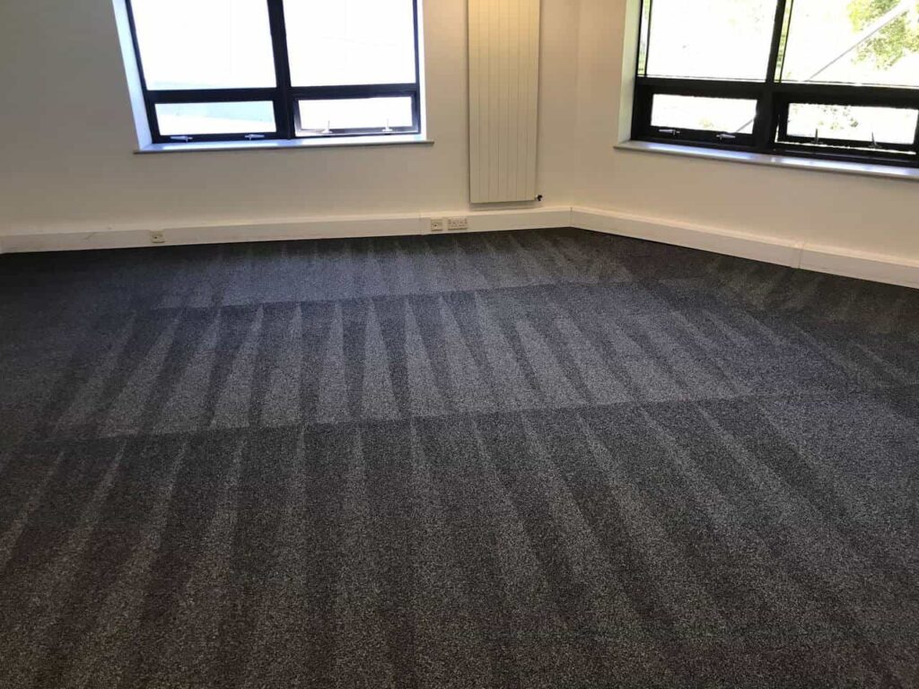 This is a photo of a grey office carpet that has just been professionally steam cleaned works carried out by Chigwell Carpet Cleaning