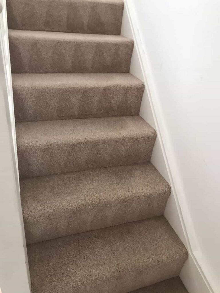 This is an after photo of a staircase with a beige carpet that has been cleaned works carried out by Chigwell Carpet Cleaning