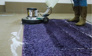 This is a photo of a purple rug being cleaned with an industrial carpet cleaner works carried out by Chigwell Carpet Cleaning